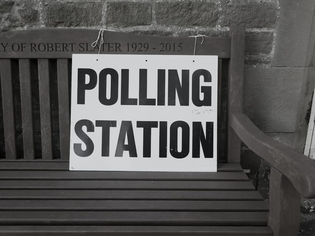 Photo of polling station sign on bench