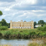 View of a palace across the river from Kew Gardens