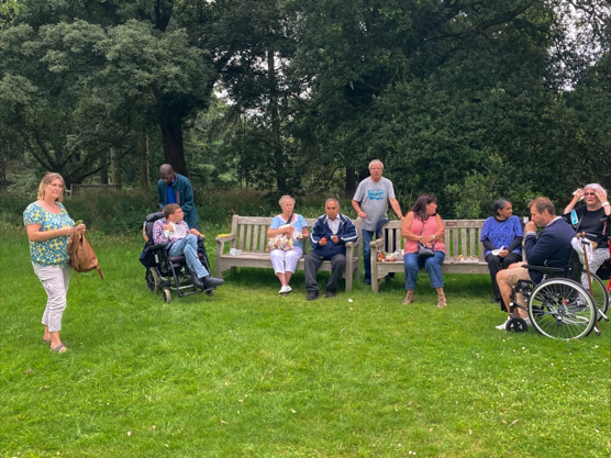 KCIL members enjoying Kew Gardens whilst taking a break on the benches.