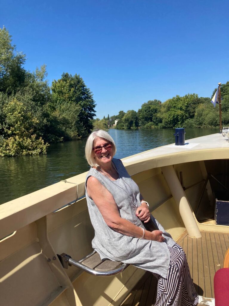 A KCIL member enjoying the sun on the river at the front of the boat