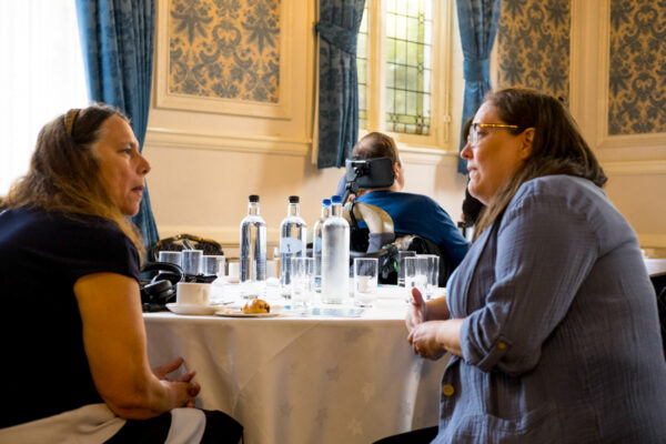 A KCIL team member talks to an attendee at the conference