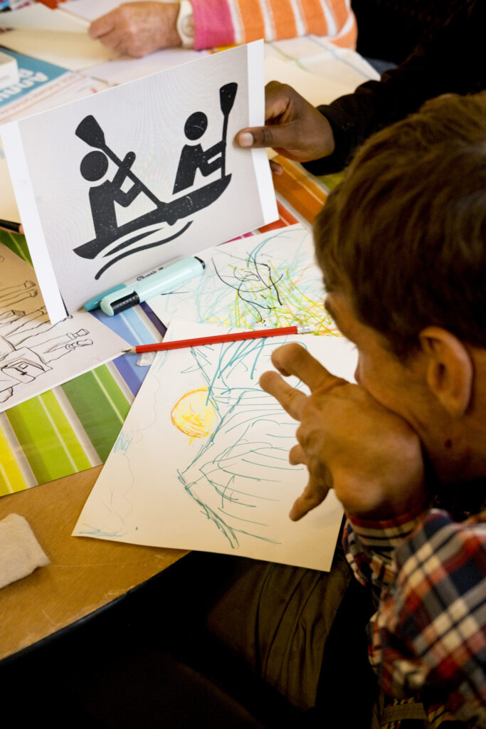 A KCIL member looking at an example piece of artwork