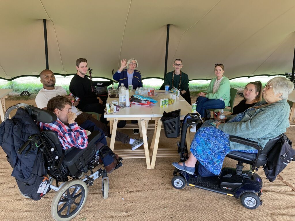 An image of people eating lunch around a table at Kew Gardens.