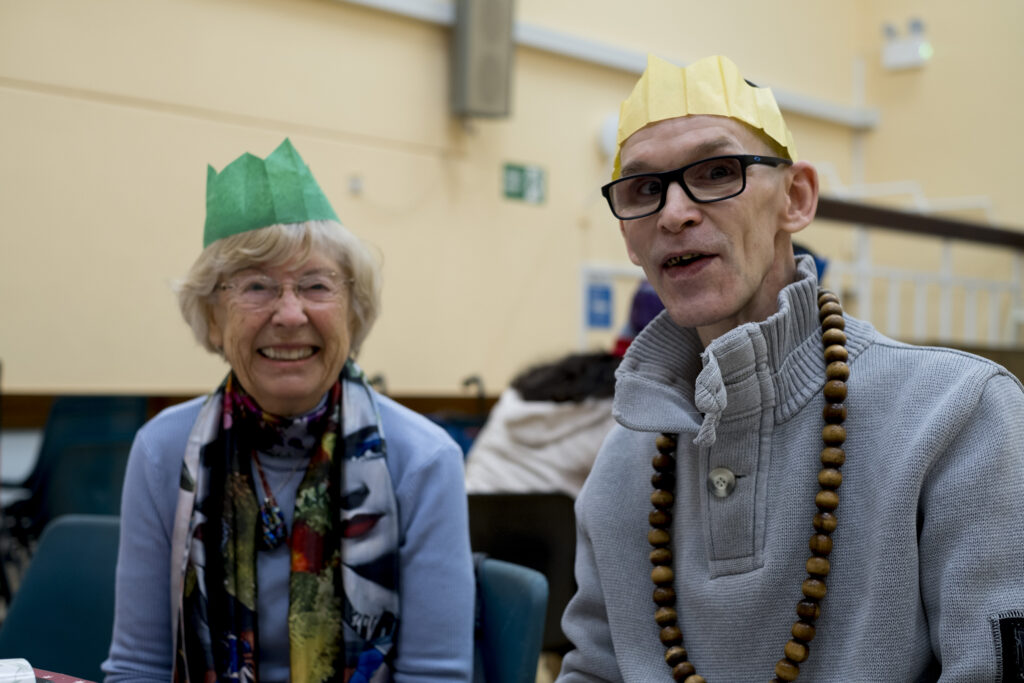 A picture of a man and a woman wearing Christmas hats.