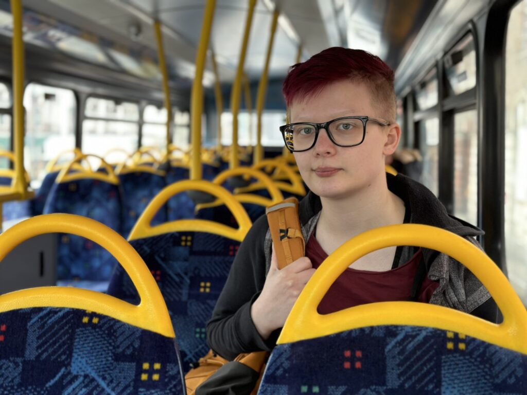 A young person sitting on the bus