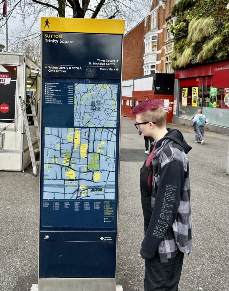 A young person looks at a Sutton street map