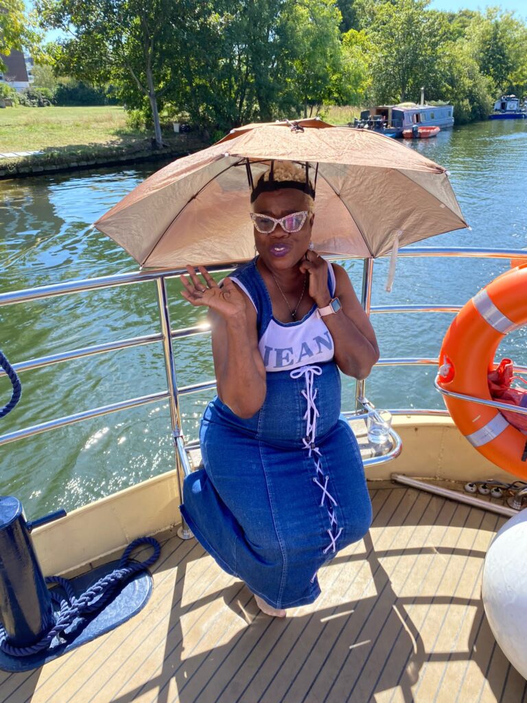 KCIL member enjoying the son on the boat with an umbrella