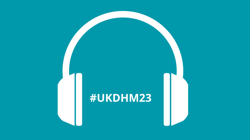 An illustration of white headphones with the text #UKDHM23