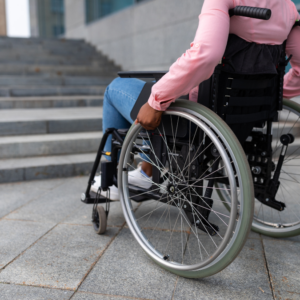 A woman in a wheelchair faces a flight of stairs