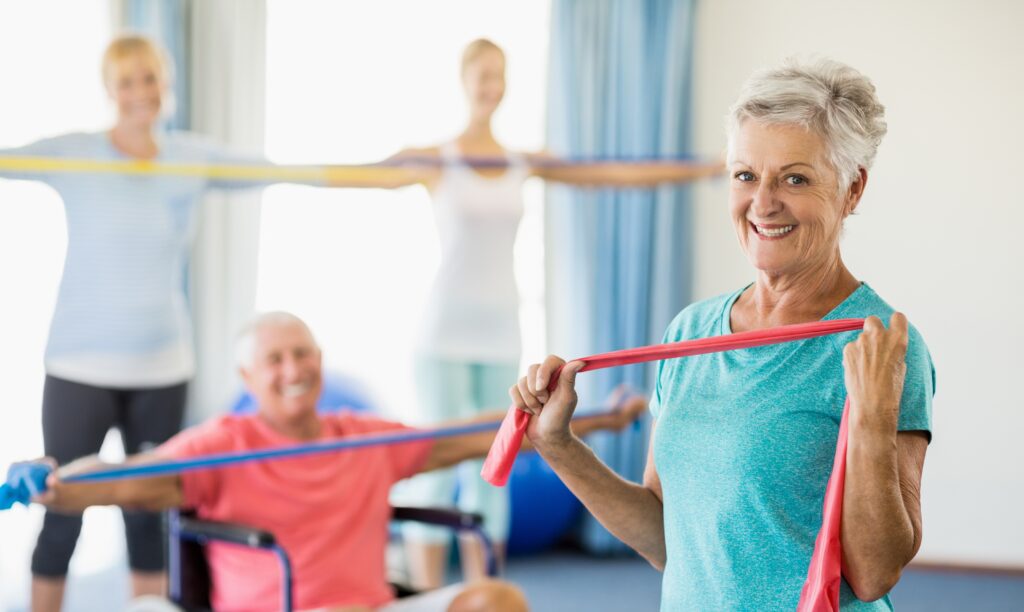 A group of older people with keep fit stretchy bands