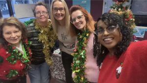 Some of the KCIL team wearing Christmas jumpers