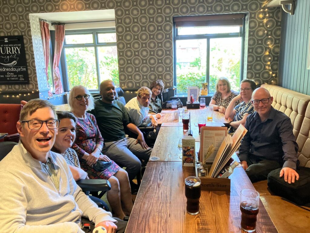 KCIL staff, trustees and service users at a pub table