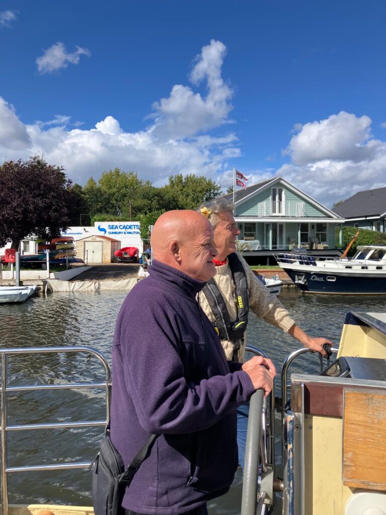 A KCIL member steers the boat alongside a crew member