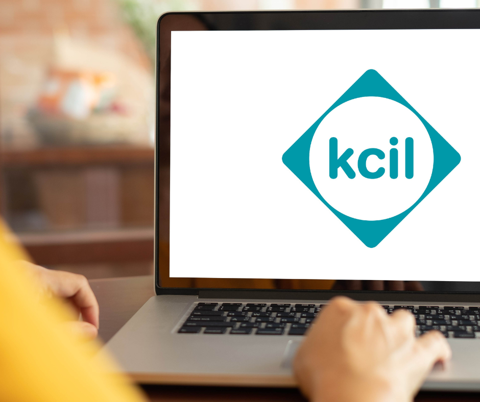 Someone on a laptop with a KCIL logo