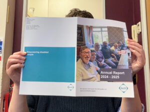 A member of the KCIL team reading a physical copy of the annual report
