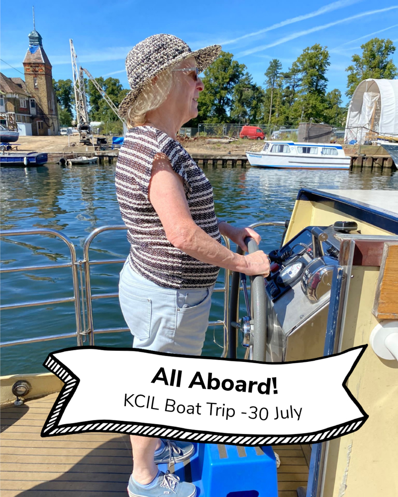 A KCIL trustee steering the boat, text reads All Aboard! KCIL Boat Trip 30 July