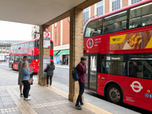 People waiting for the bus at the Wood Street bus stop in Kingston. There is a 281 bus