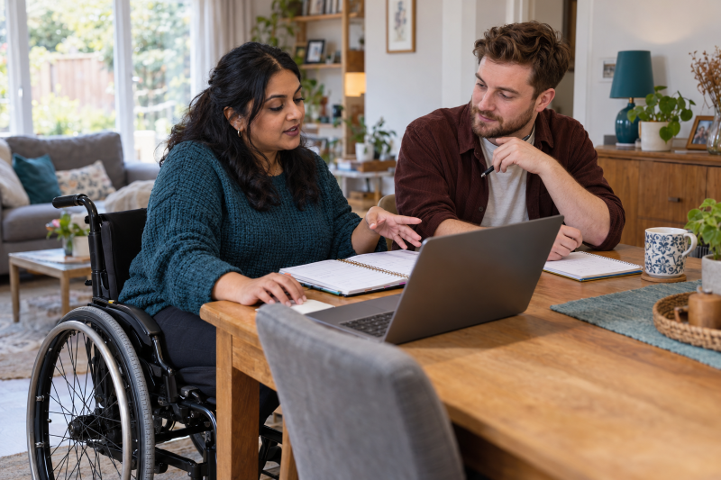 wheelchair user discussing plans with their PA